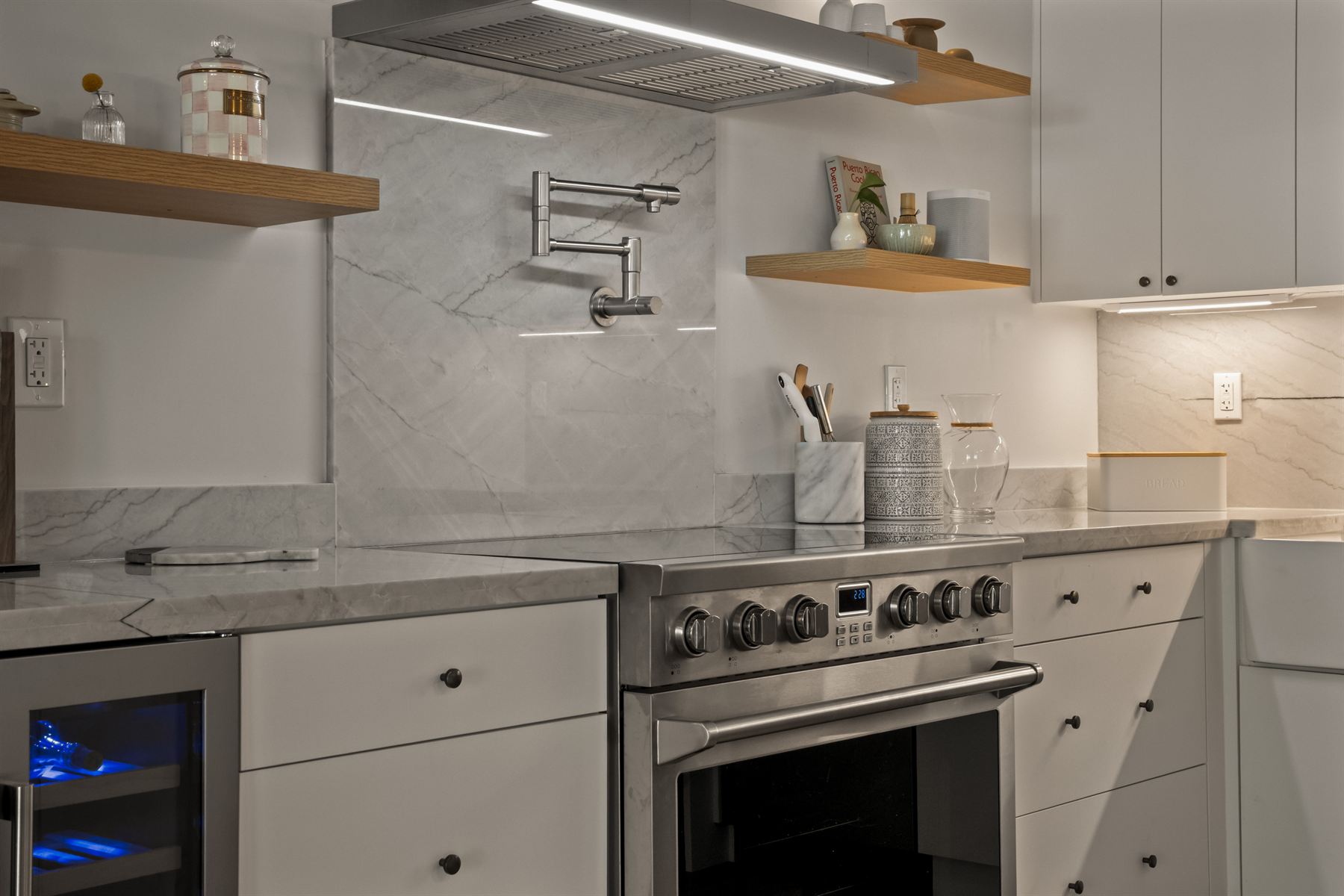 Open-concept white kitchen remodel in Weston, FL with waterfall island